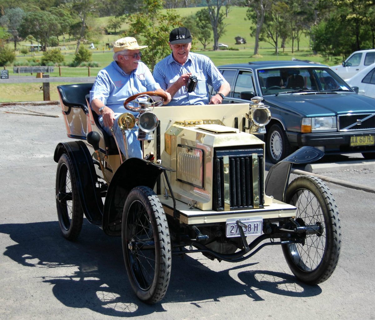 People driving The Australian MOTORLIFE Museum vintage car