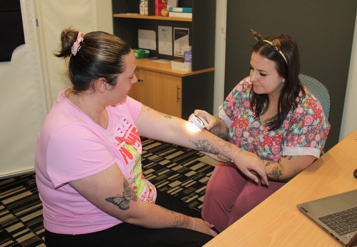 Dapto Healthcare Melanographer Nikketa Thompson checking Brooke Adams for skin cancer.