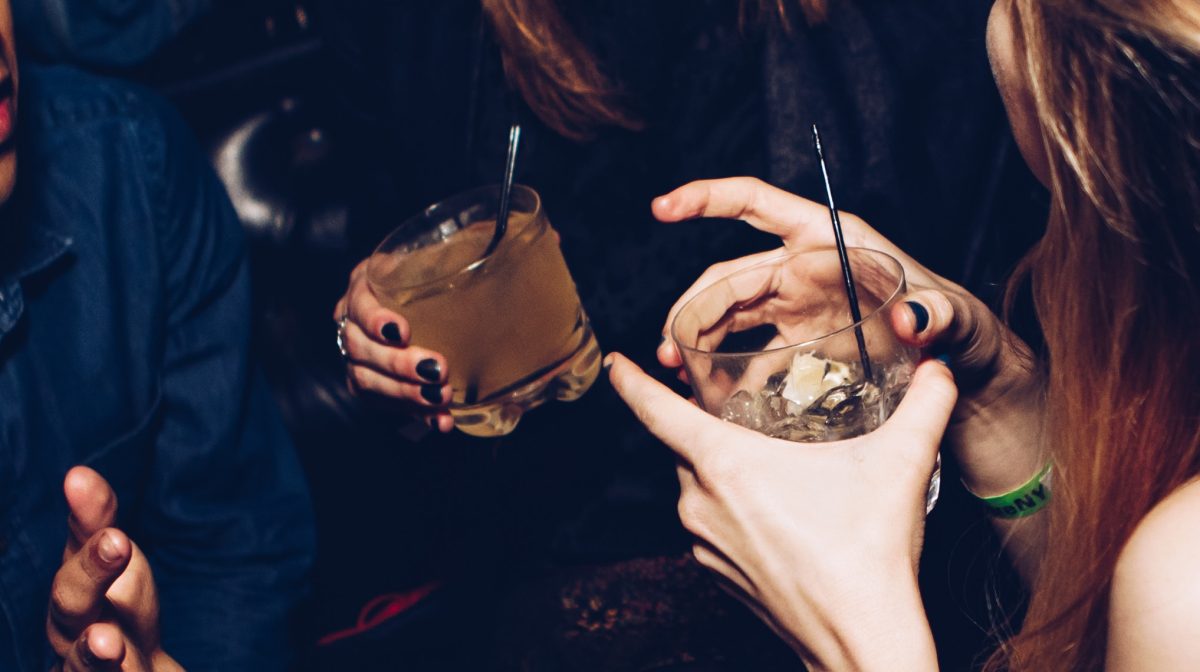 People holding glasses with alcohol.