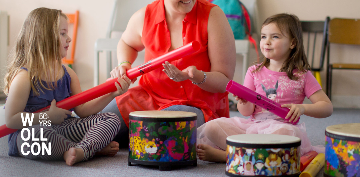 Children and an adult play musical instruments