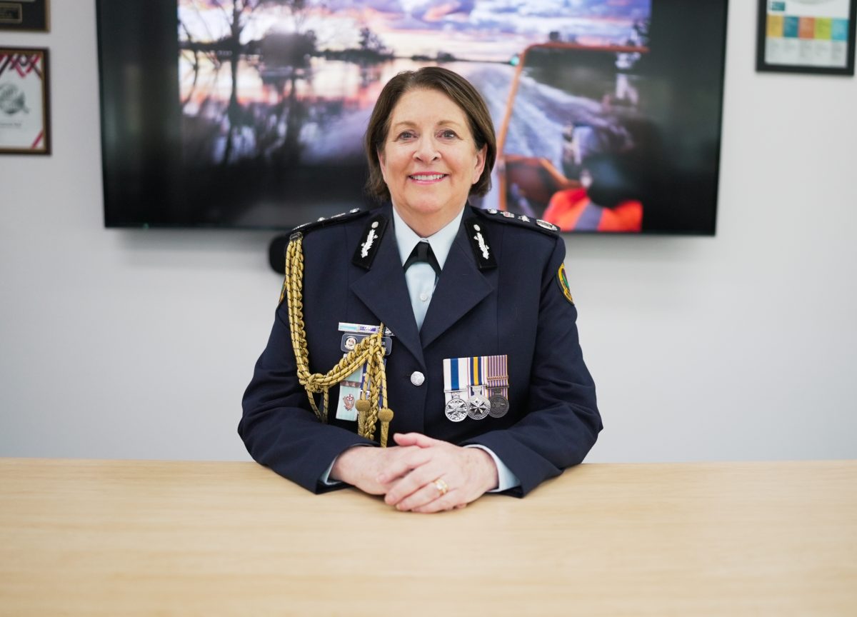 NSW State Emergency Service Commissioner Carlene York APM sits at a desk with her hands folded