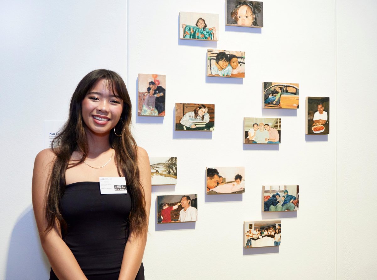 Kya Stwaski of Corpus Christi Catholic High School stands in front of her artworks at the Art Express exhibition