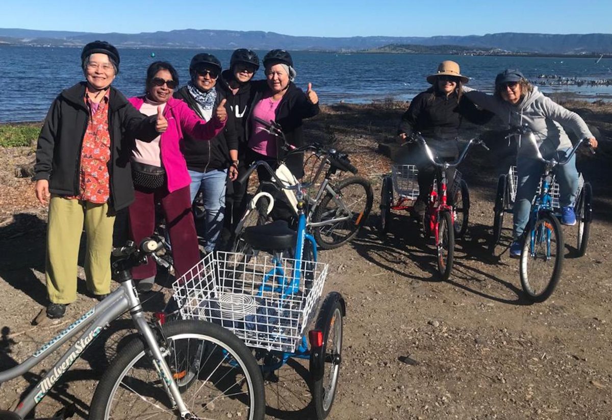 Group of women with tricycles.