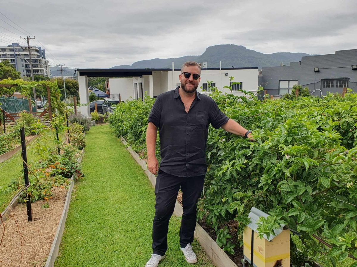 Ryan Aitchison checks out the passionfruit crop at the Smith Street Distillery urban farm in Wollongong.