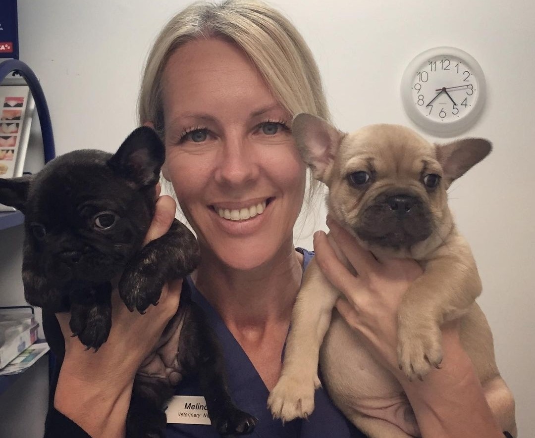 Melinda with two puppies. 