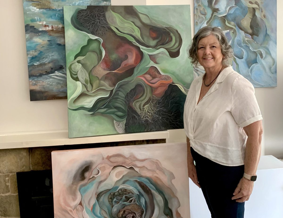 Artist Susan McAlister in front of artworks