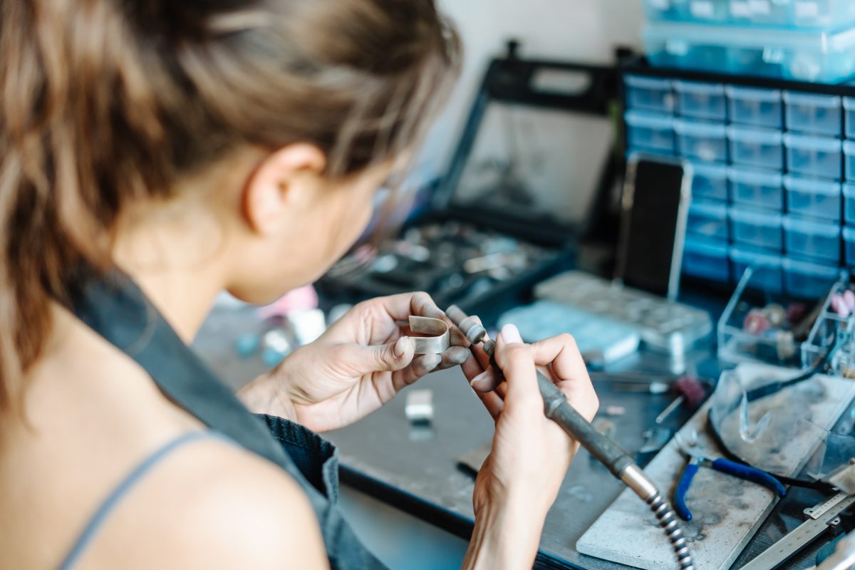 A girl works on a jewellery in the workshop