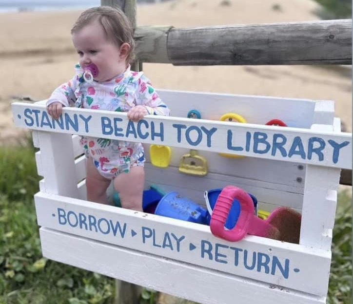 Toddler stands in the Stanwell Park Beach Toy Library.