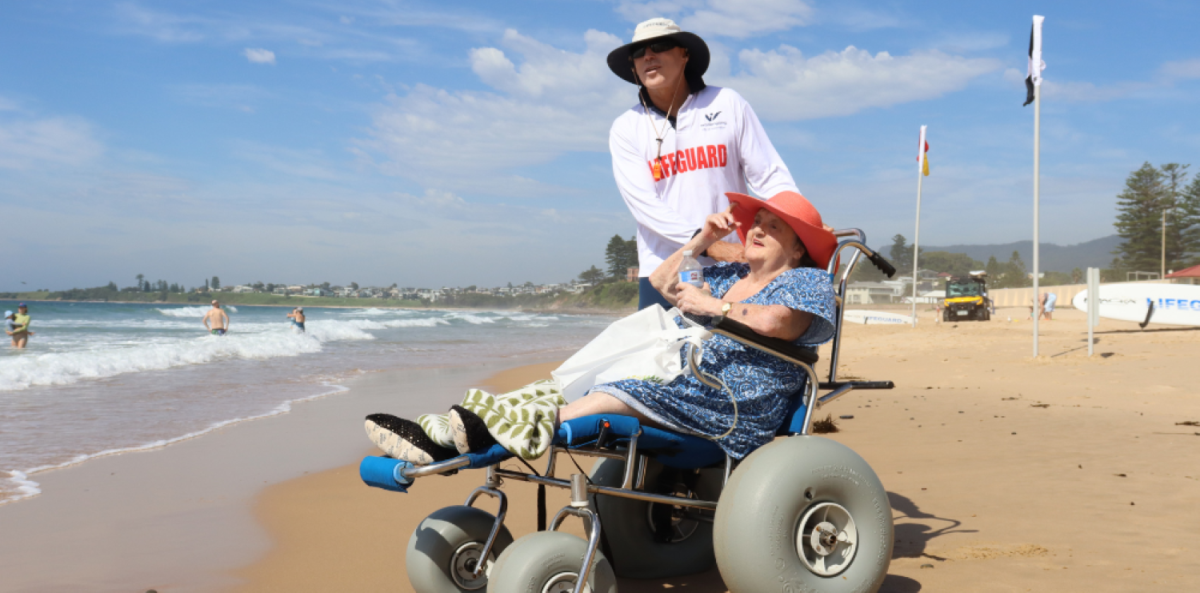 Woman in a wheelchair on a beach.