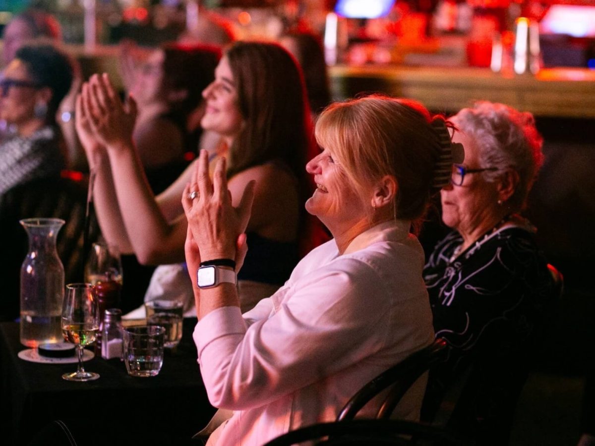 women clapping at a show