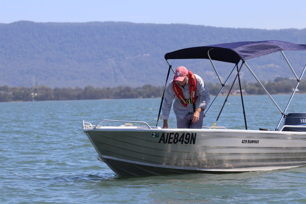 Man wearing a lifejacket on a boat.