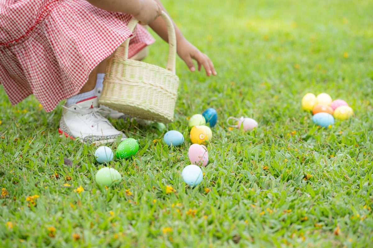 Girl enjoying outdoor activities in the park including a run to collect beautiful Easter eggs.