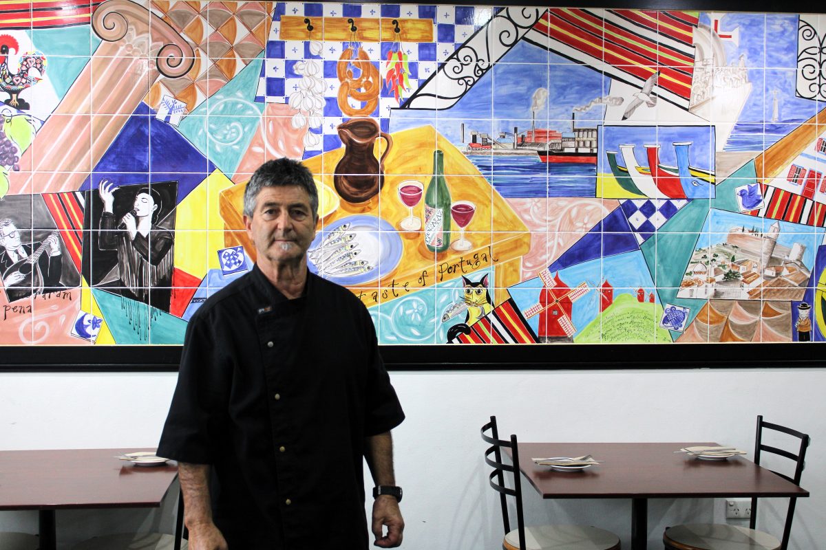 man standing in front of mural in club premises