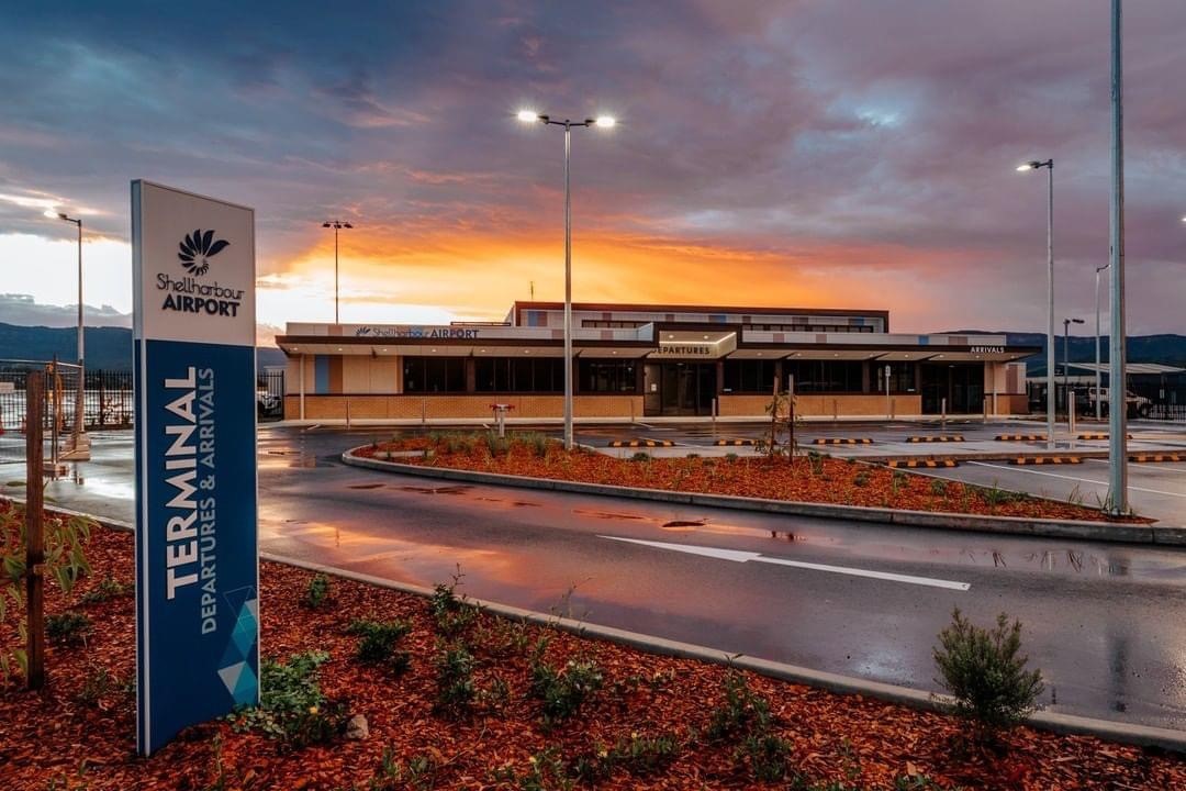 Sun sets behind the airport building.