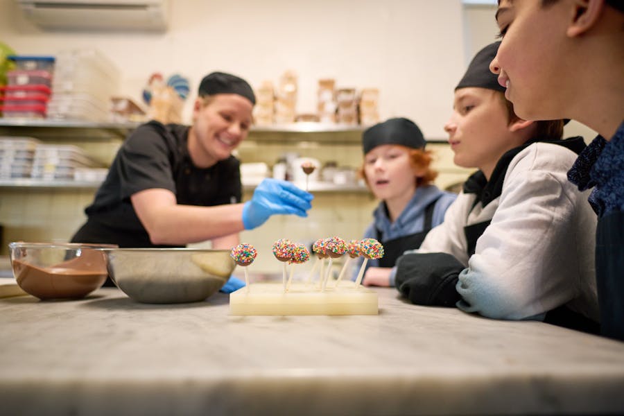 Woman makes cake pops with kids