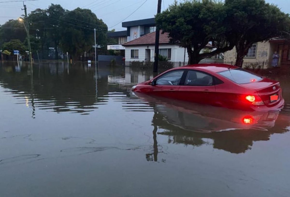 partly submerged car in flooded street