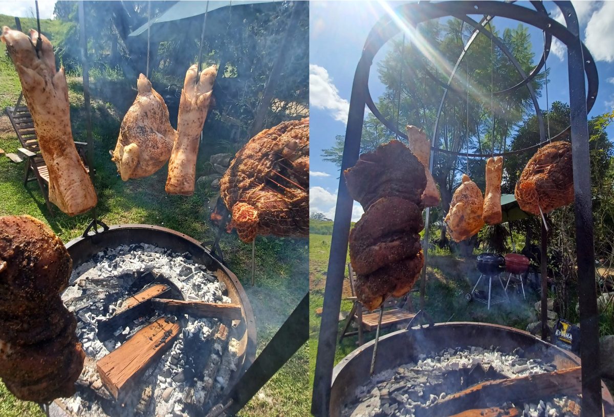 various meats cooking over a wood fire