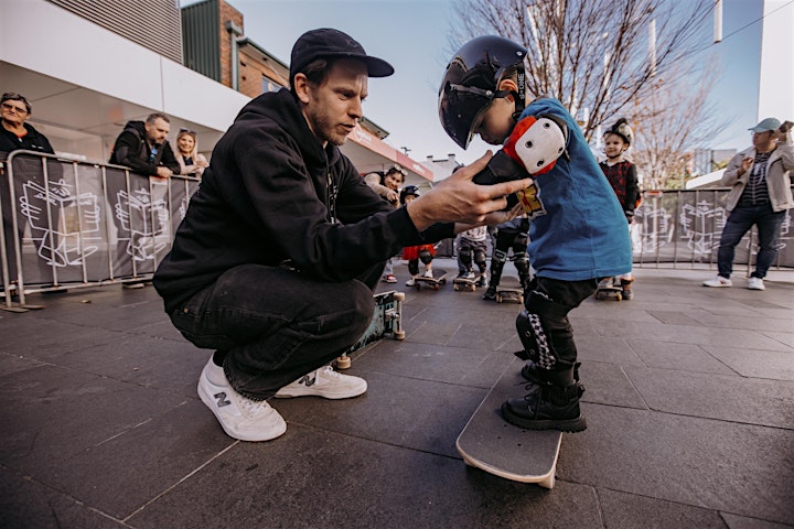 Man shows little boy how to skate