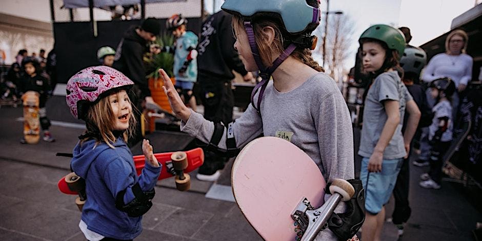 Two young skater girls say hello