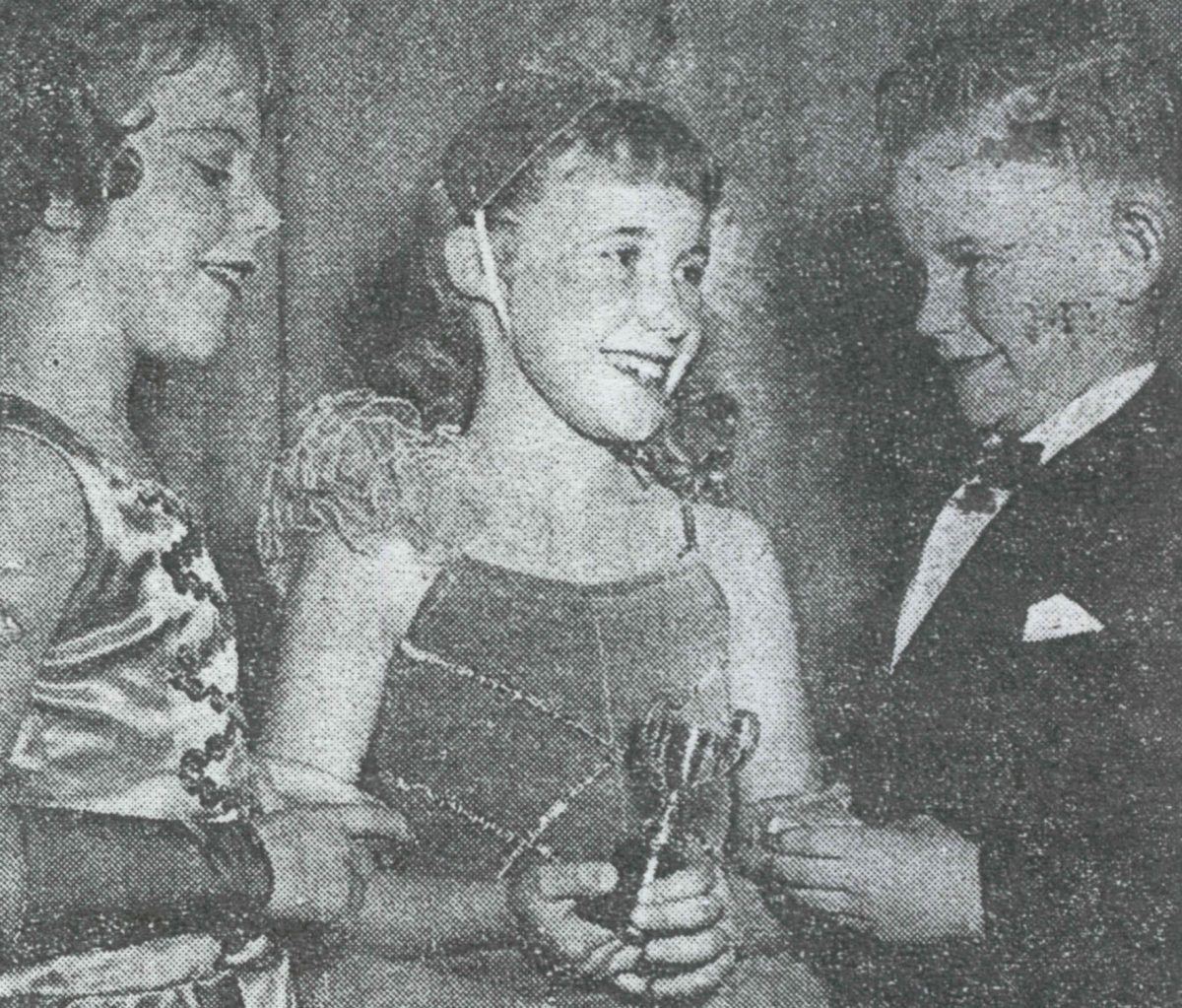 Black and white picture of young girl being congratulated for coming first in the tap section of the Wollongong Eisteddfod