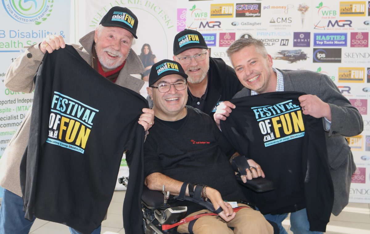 Group of four men with Festival of Fun shirts.