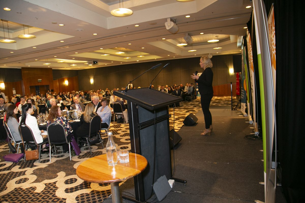 Jodi Bush speaks to a packed One Door Illawarra luncheon in 2023 