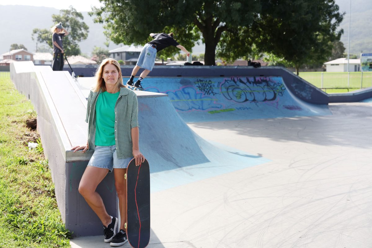 woman with skateboard at skate bowl