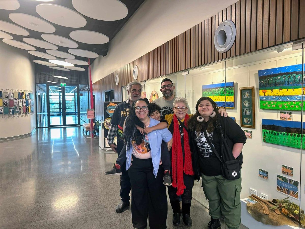 Group of people with NAIDOC Week display