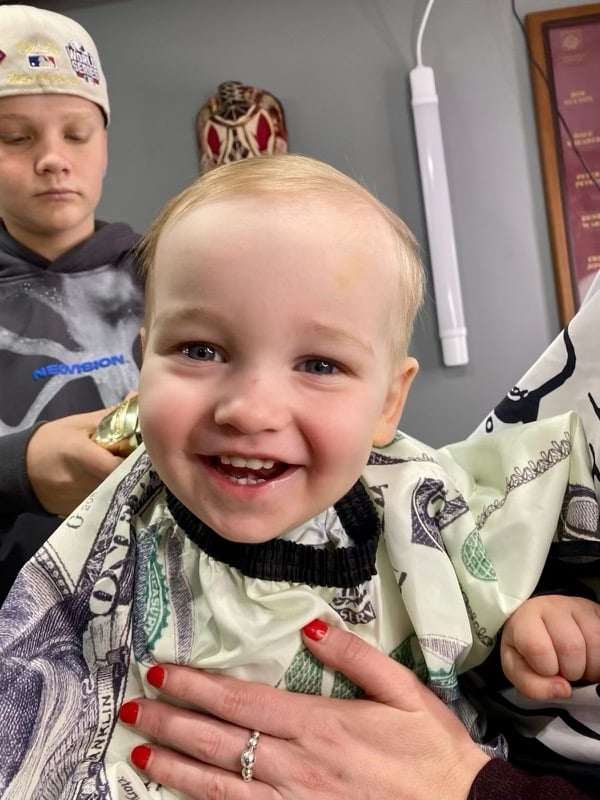 boy cutting a toddler's hair