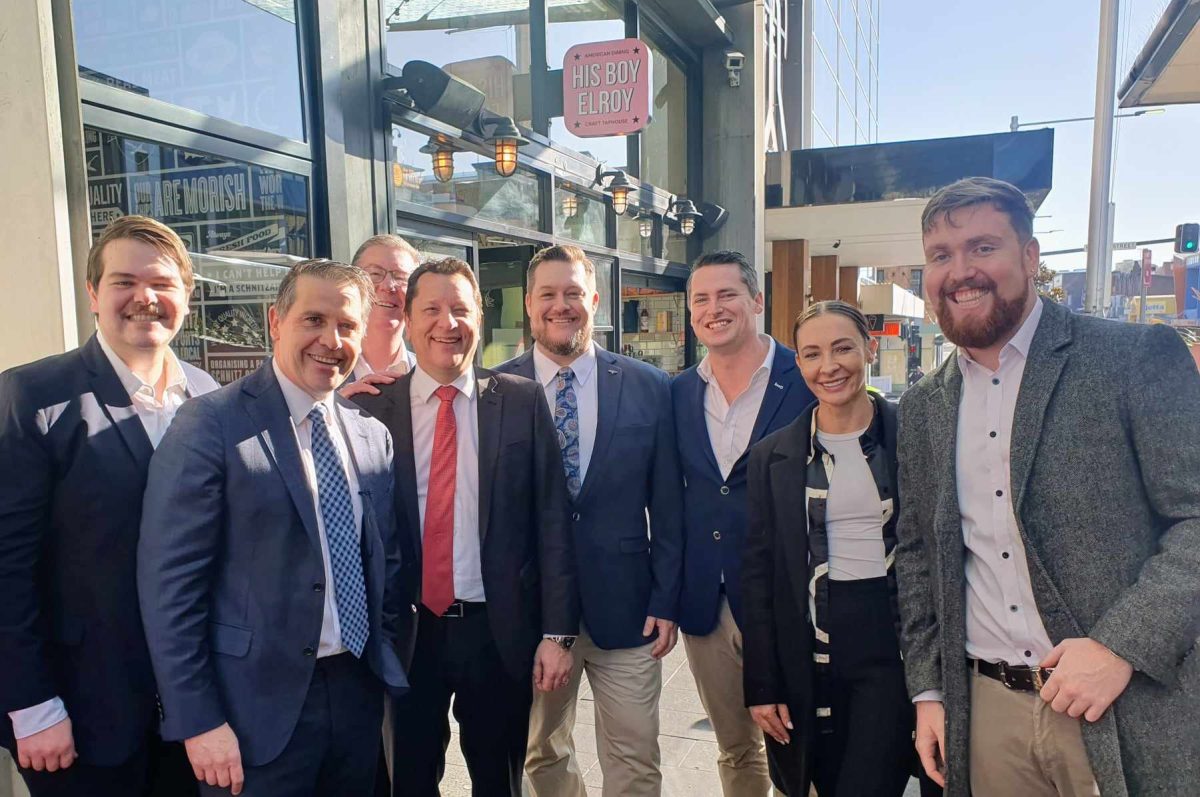 Group of people in business attire outside shops