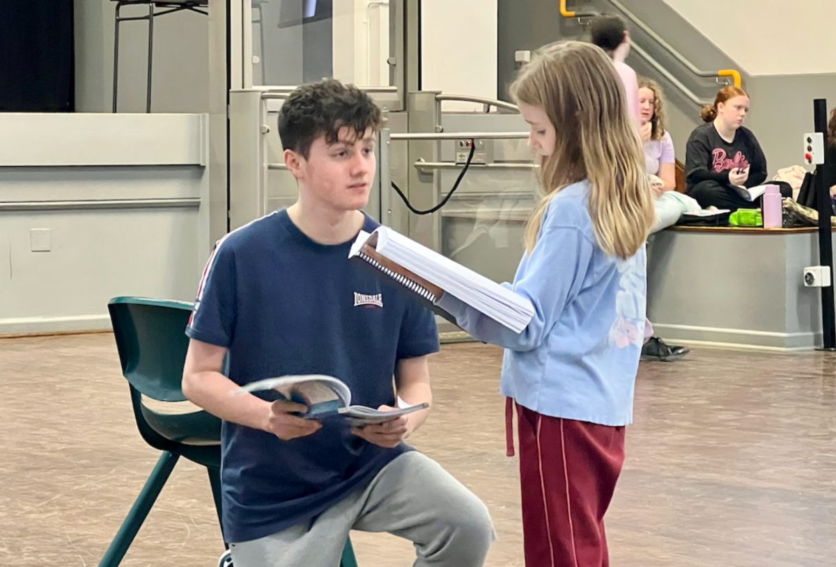 a boy and a girl rehearsing for a play