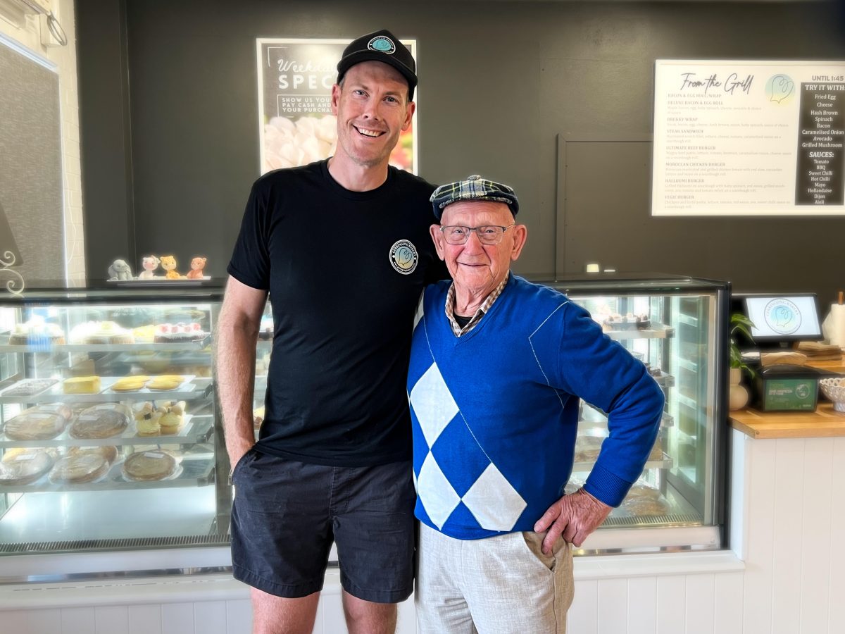 Two men in cake shop