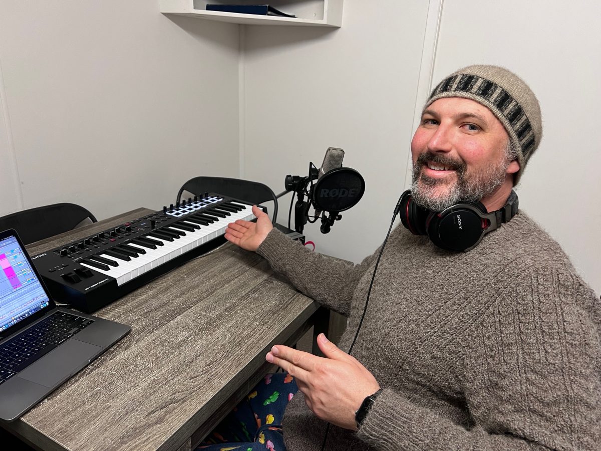 Man with laptop and musical keyboard