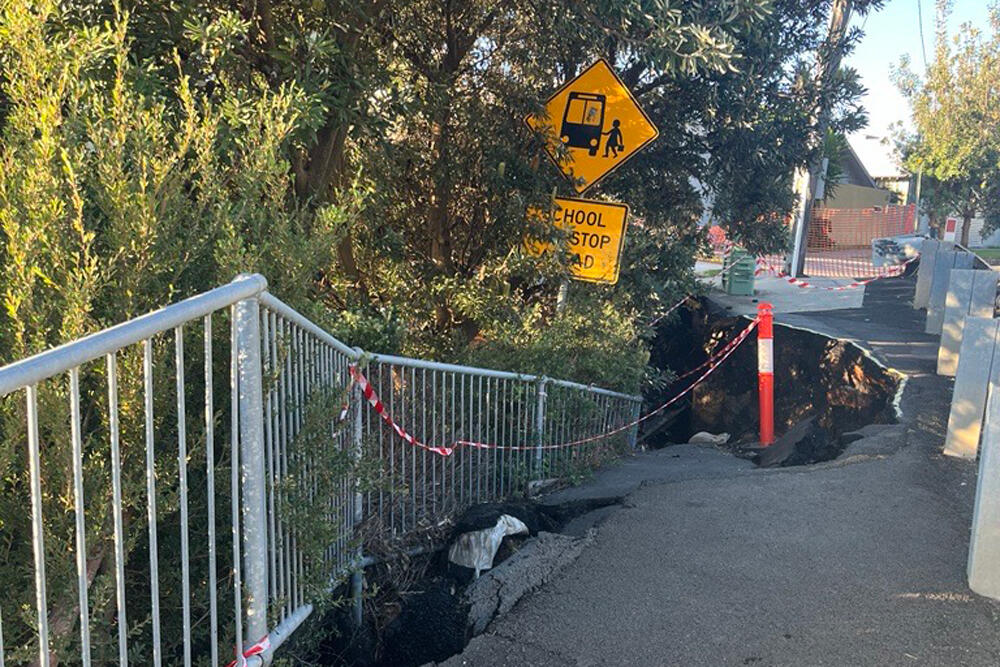 Damaged footpath and road.