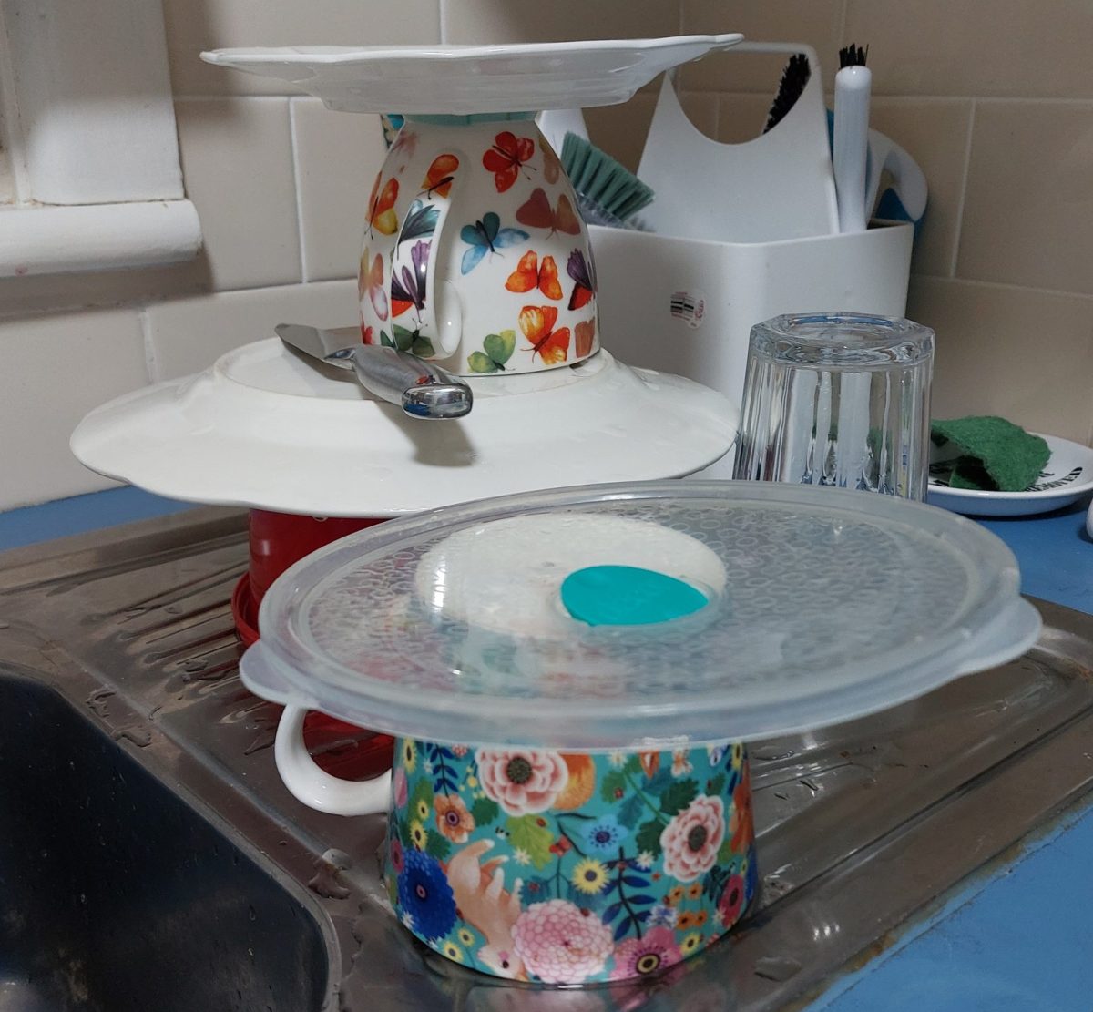 Dishes stacked on a sink.