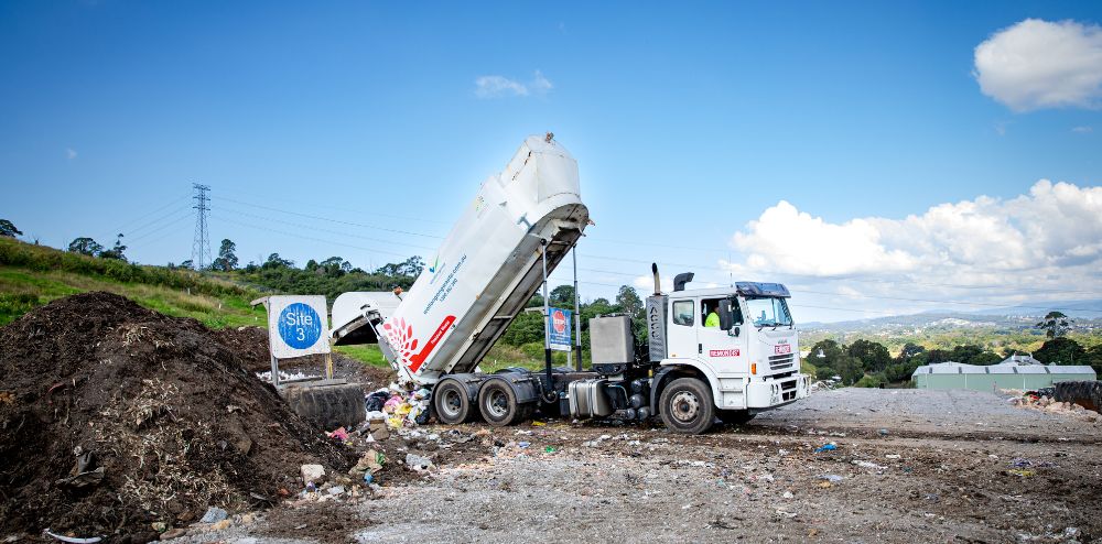 Garbage truck emptying a load of rubbish.