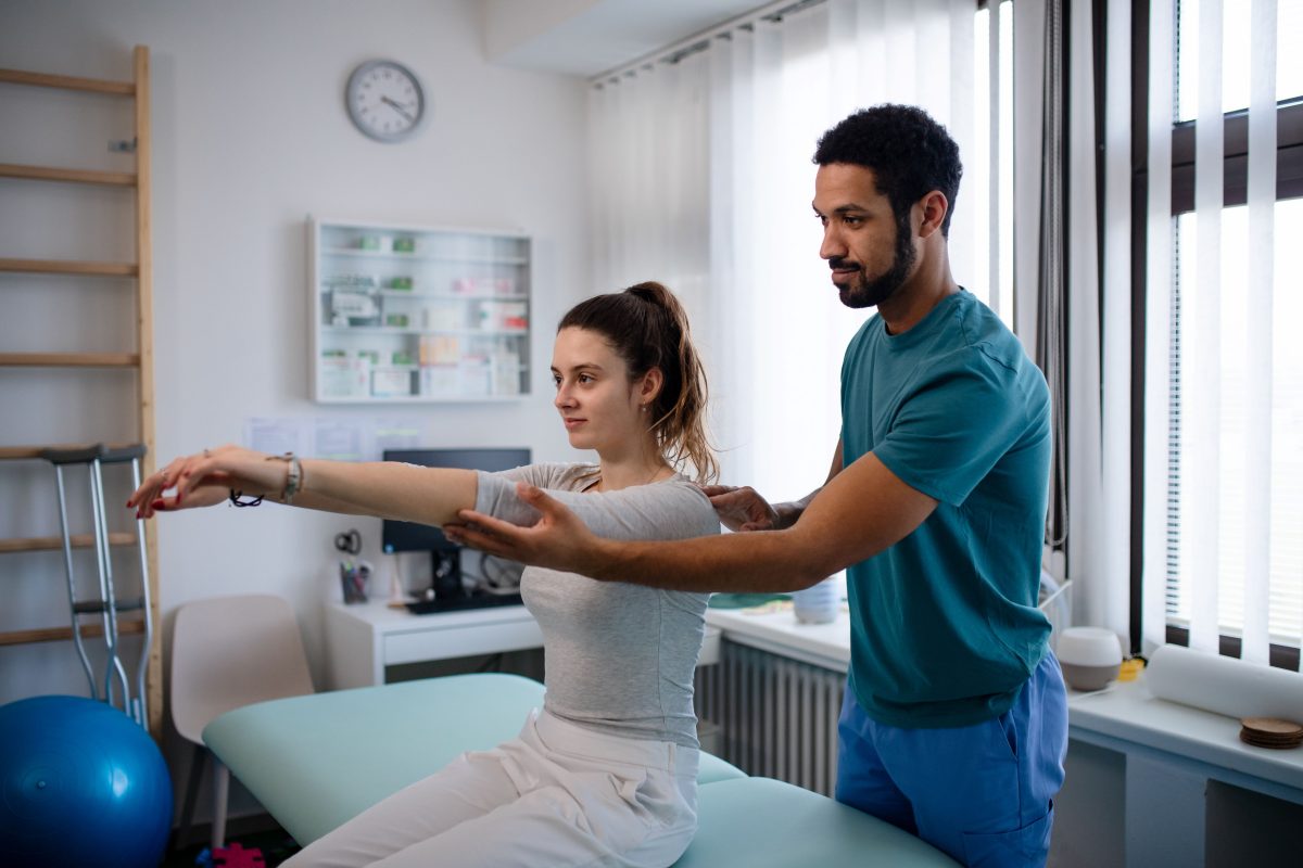 physiotherapist working with patient