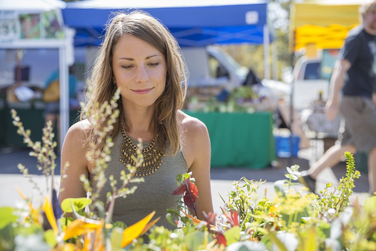 Woman browses flowers at a market