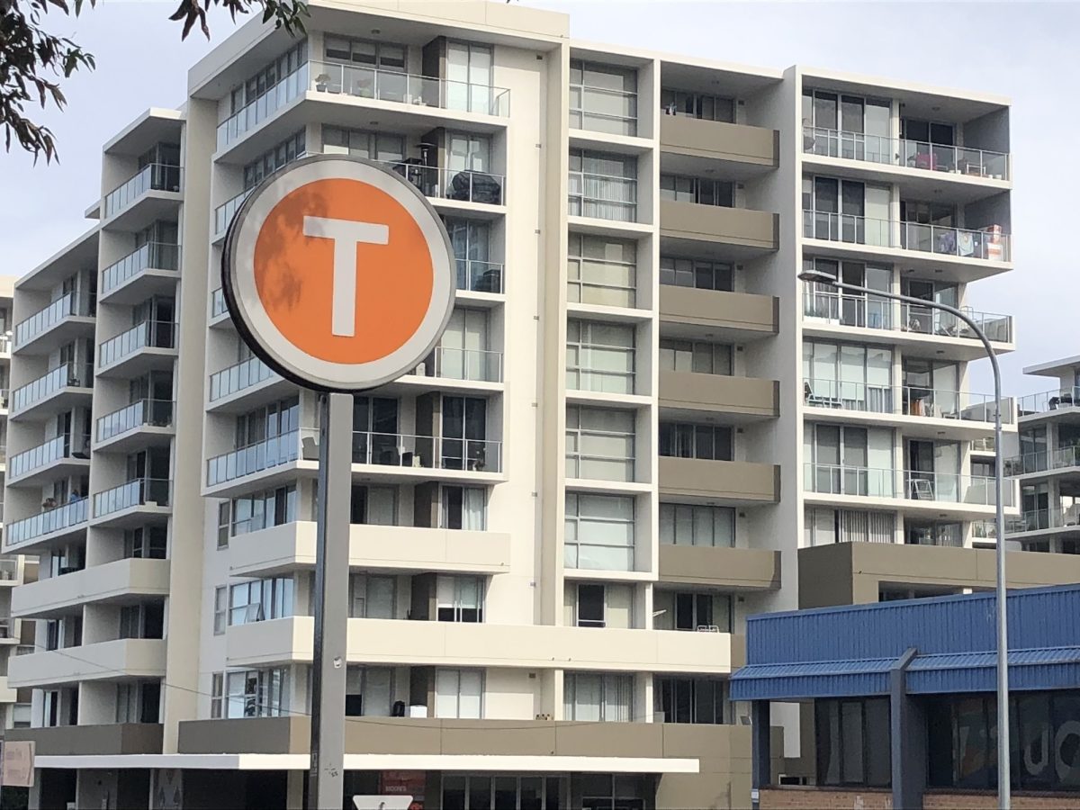 T sign in front of building