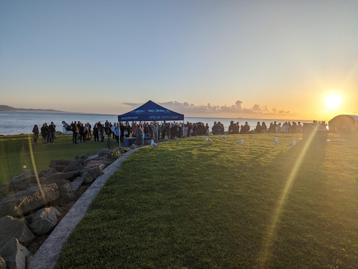 People gather on the coast for Lifeline's Out of the Shadows Walk