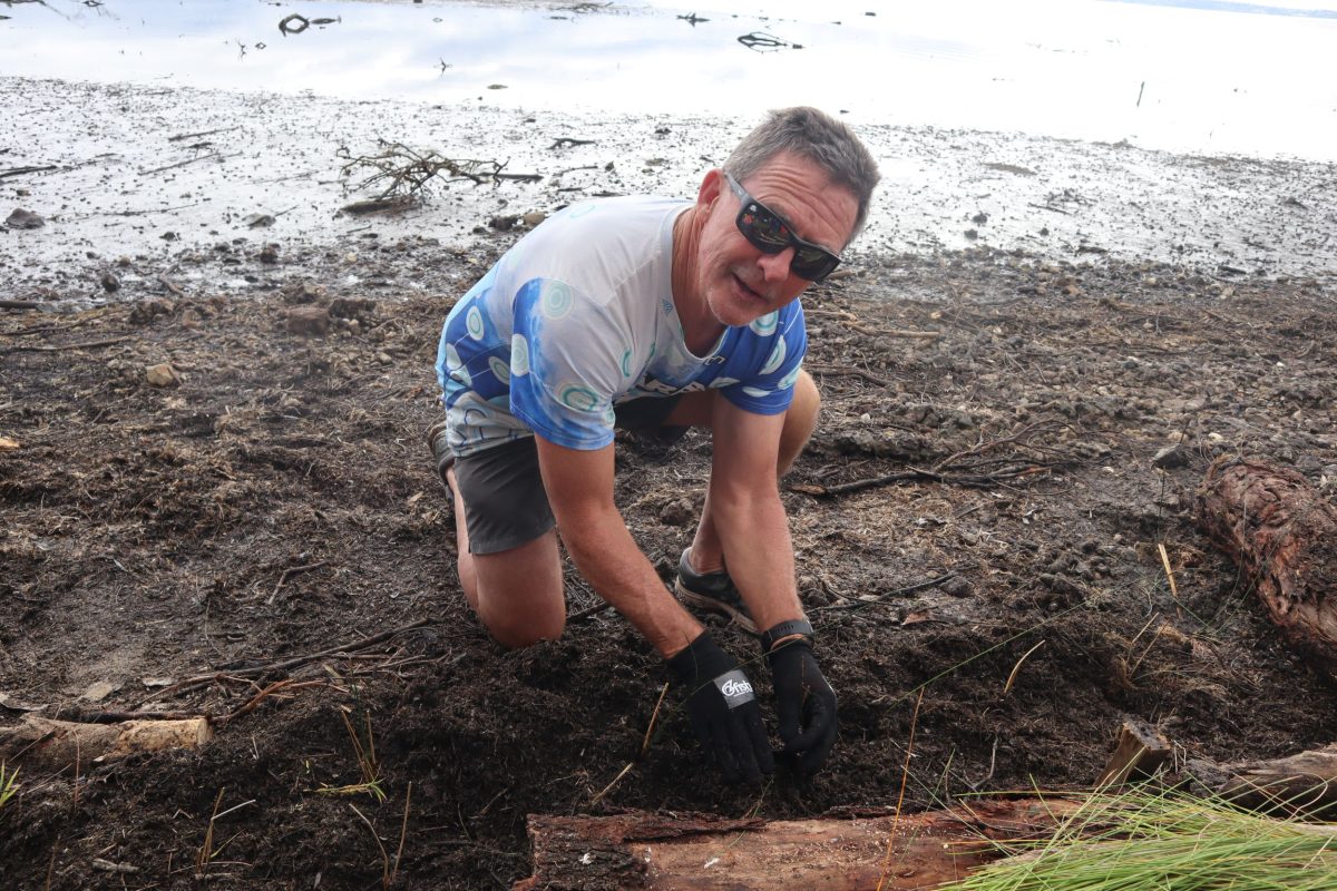 Man digging near lake