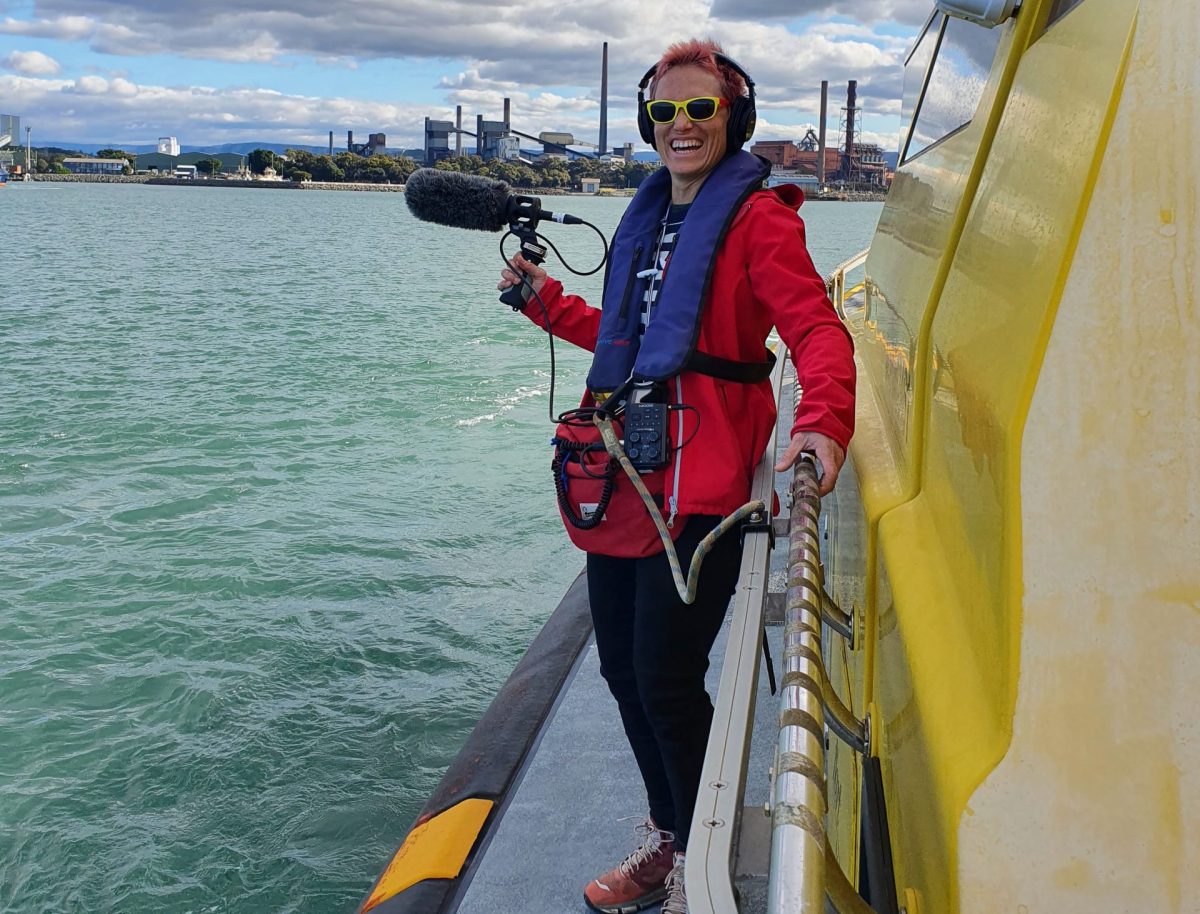 a woman recording sounds while on a boat