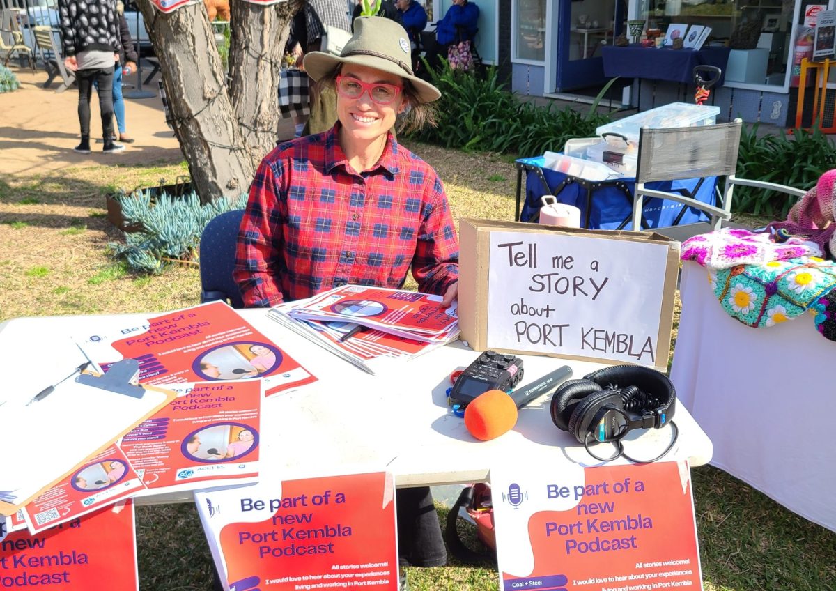 a woman at a stall with a sign that says "Tell me a story"