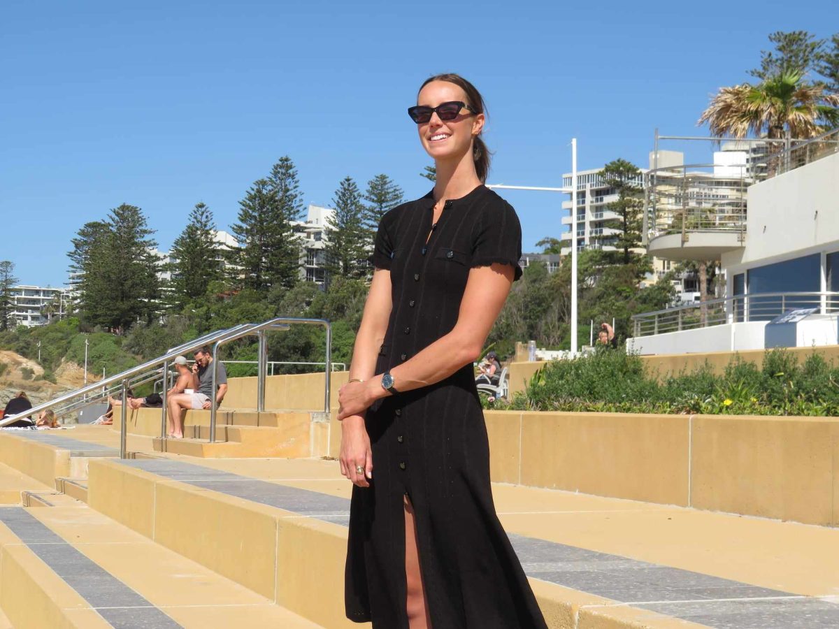 Olympian Emma McKeon on the steps of the North Wollongong promenade that has been named in her honour.