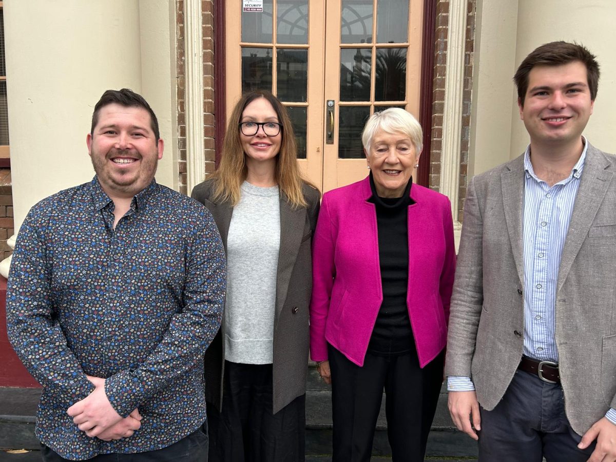 Four people standing in front of a door