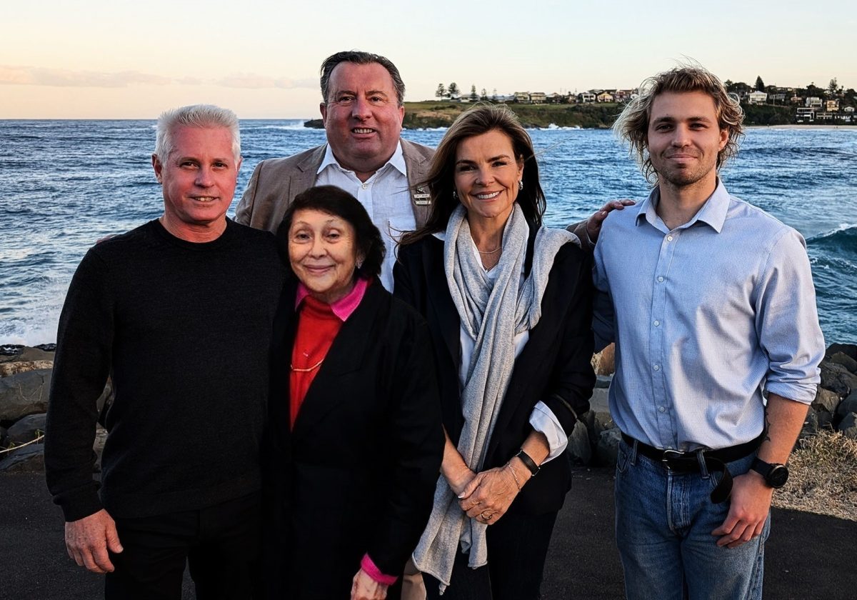 Five people in front of ocean