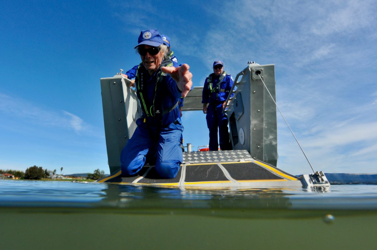 Man reaching out over water