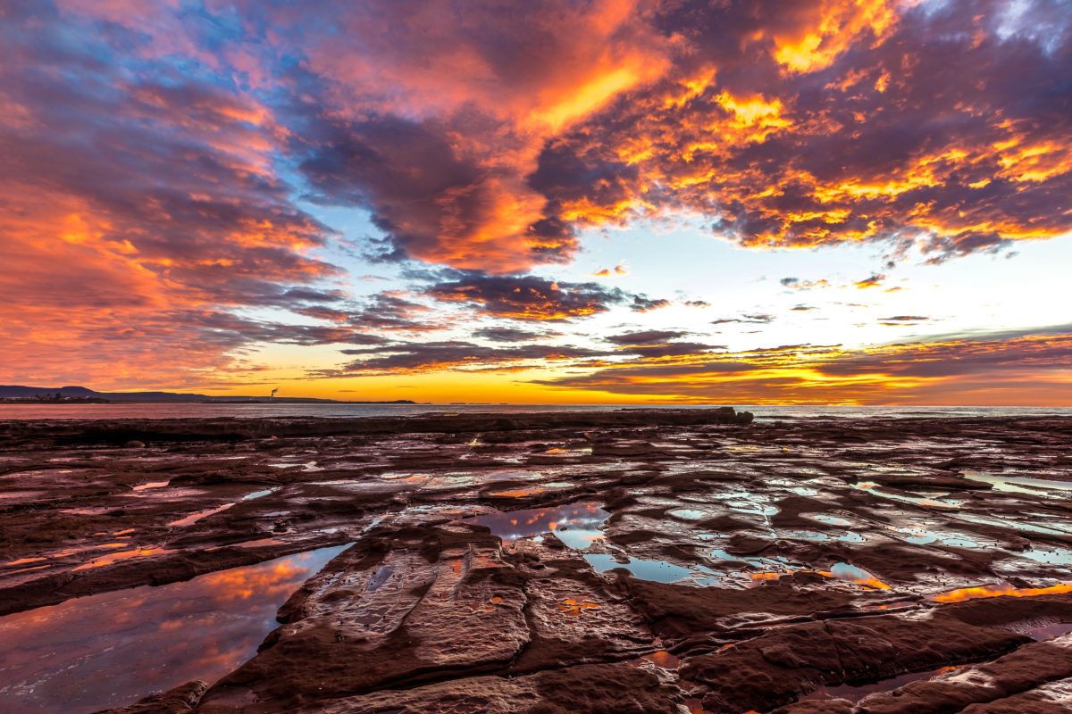 Sunrise over rocks and water