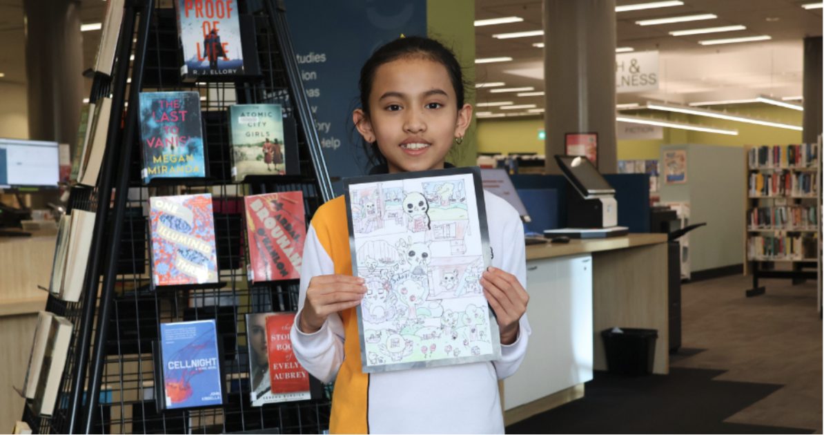 Child holds Book Week drawing up