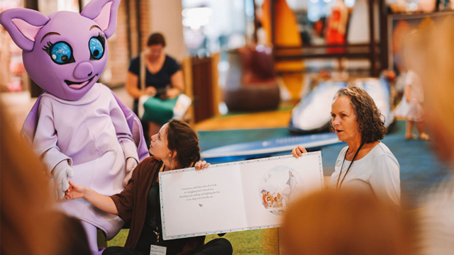 Woman reads story to kids at Stockland Shellharbour